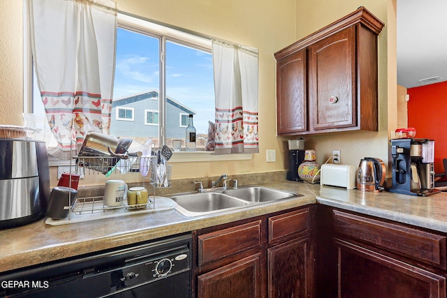 kitchen featuring visible vents, a sink, black dishwasher, and light countertops