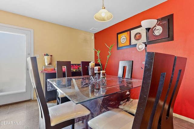 dining room with baseboards, visible vents, and tile patterned flooring