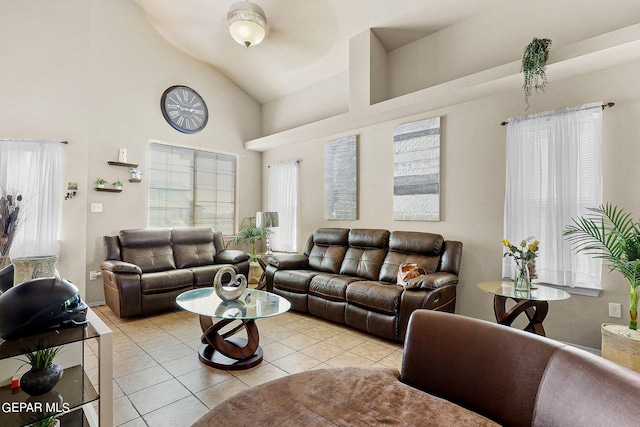 living room with light tile patterned flooring and high vaulted ceiling