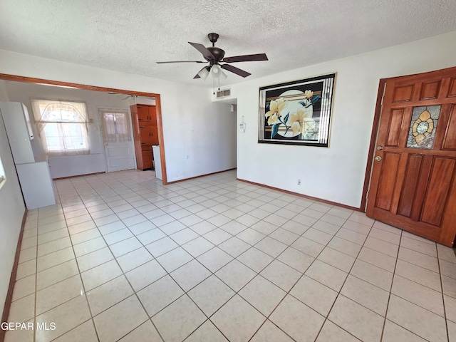 interior space featuring a textured ceiling and ceiling fan