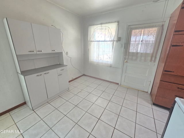 kitchen with white cabinetry and light tile patterned floors