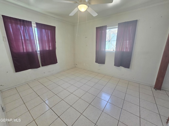 empty room featuring ceiling fan, light tile patterned floors, and crown molding