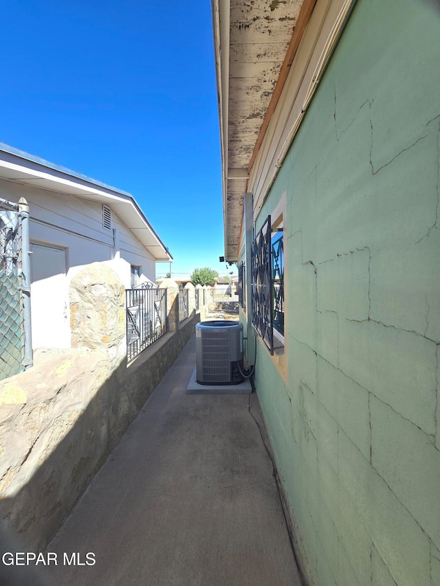 view of side of home featuring a patio and central air condition unit