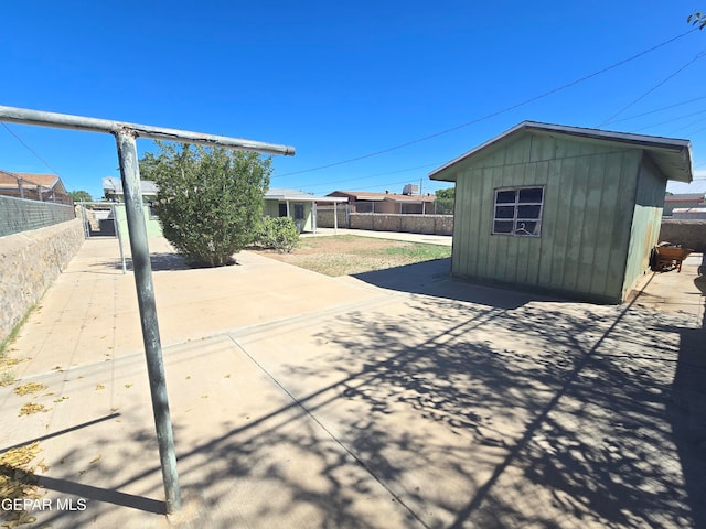 view of patio featuring a storage unit