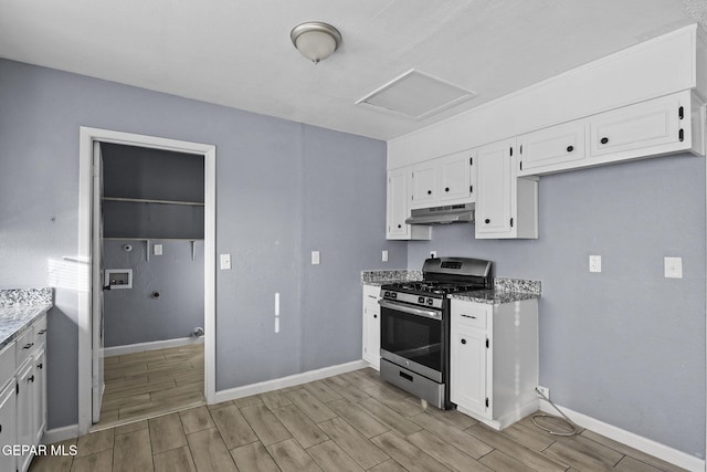 kitchen featuring light stone countertops, light wood-type flooring, white cabinetry, and stainless steel range with gas cooktop