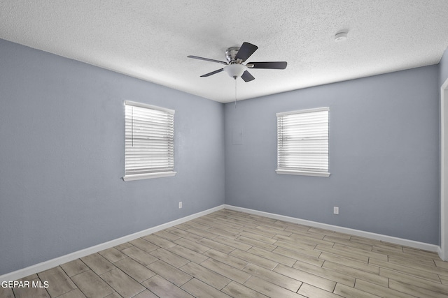 unfurnished room with ceiling fan, a textured ceiling, and light hardwood / wood-style flooring