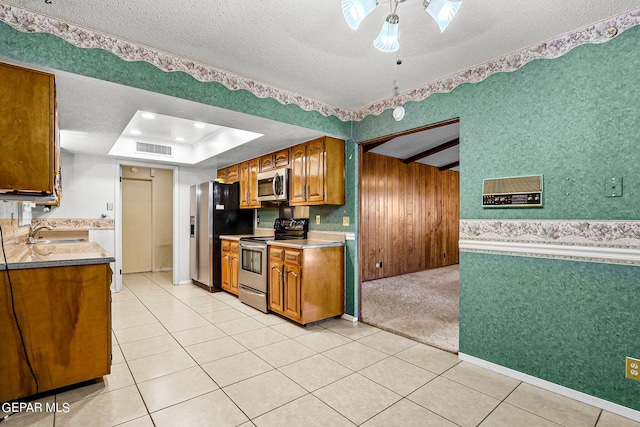 kitchen featuring appliances with stainless steel finishes, a textured ceiling, ceiling fan, sink, and light tile patterned flooring