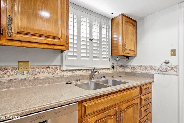 kitchen featuring dishwashing machine and sink