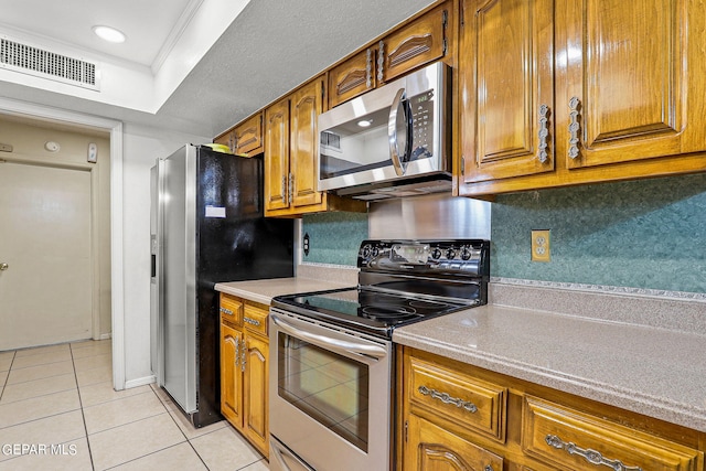 kitchen featuring decorative backsplash, appliances with stainless steel finishes, crown molding, and light tile patterned flooring