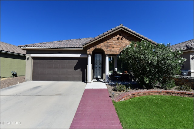 single story home with a front lawn and a garage