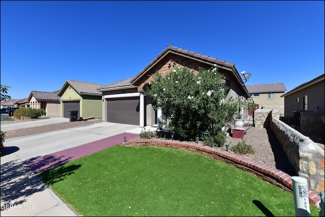 view of front of property with a garage and a front lawn