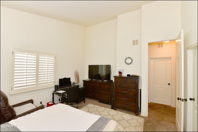 bedroom featuring light carpet