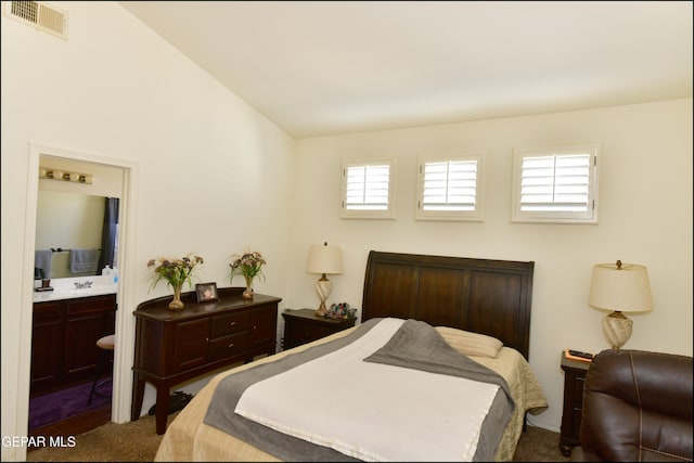 carpeted bedroom featuring ensuite bath, sink, and multiple windows