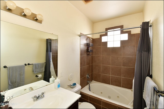 full bathroom featuring vanity, shower / bath combo with shower curtain, and toilet