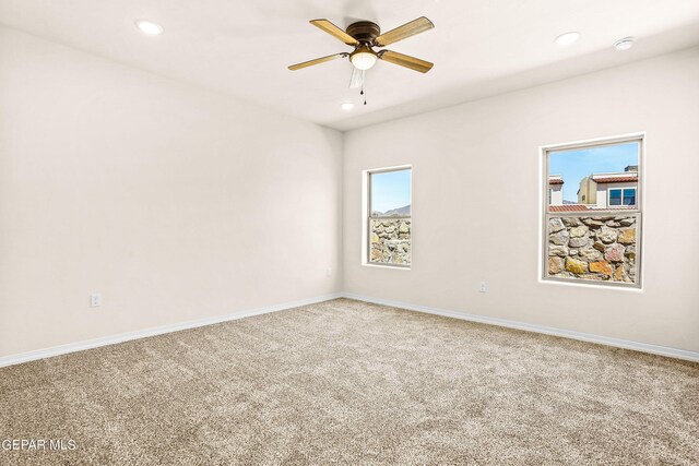 spare room featuring ceiling fan and carpet flooring