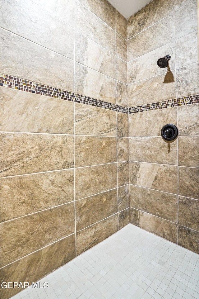 bathroom with tiled shower