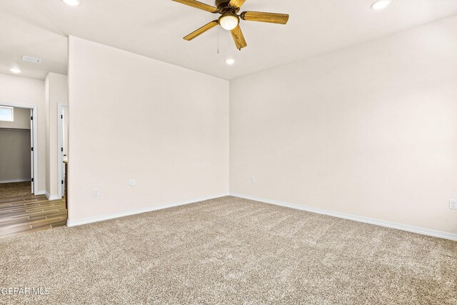 spare room with hardwood / wood-style floors and ceiling fan