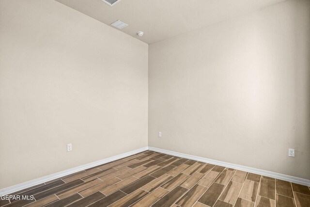 unfurnished room with dark hardwood / wood-style floors