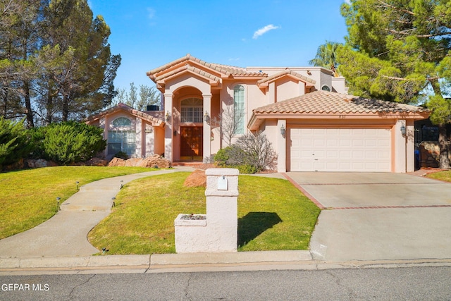 mediterranean / spanish home featuring a front lawn and a garage