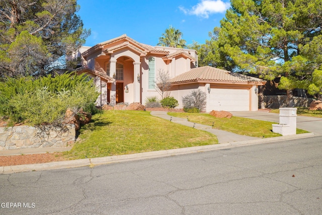 851 Via Alegre Ln, El Paso, TX 79912 - mediterranean / spanish-style home with stucco siding, a tile roof, a garage, a front lawn, and driveway