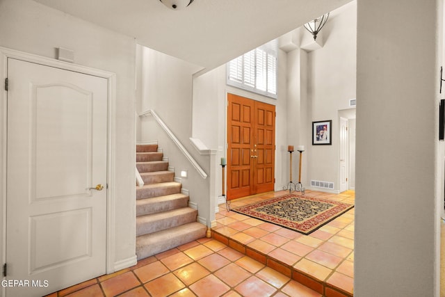 851 Via Alegre Ln, El Paso, TX 79912 - entryway featuring light tile patterned floors, stairs, and a towering ceiling