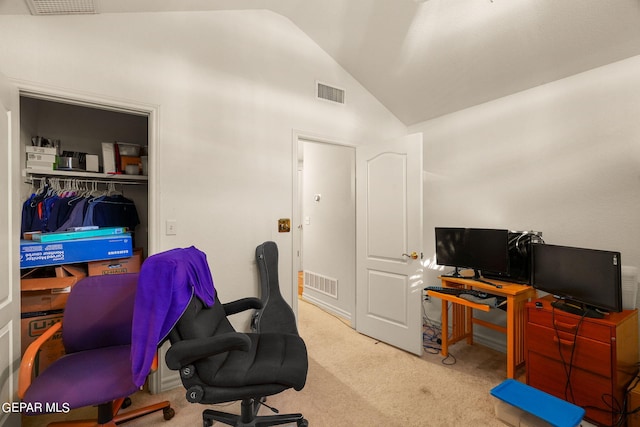 carpeted home office with high vaulted ceiling