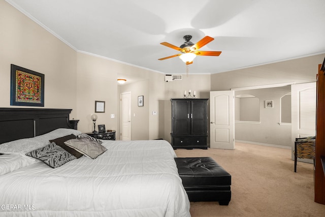 carpeted bedroom with ornamental molding and ceiling fan