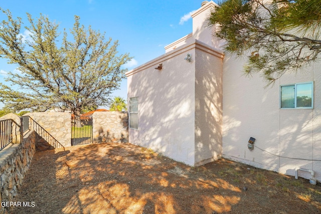 851 Via Alegre Ln, El Paso, TX 79912 - view of side of home featuring a gate and stucco siding