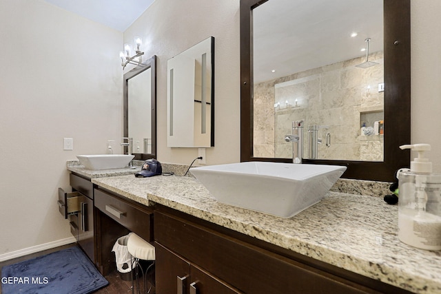 bathroom featuring hardwood / wood-style flooring, vanity, and a tile shower