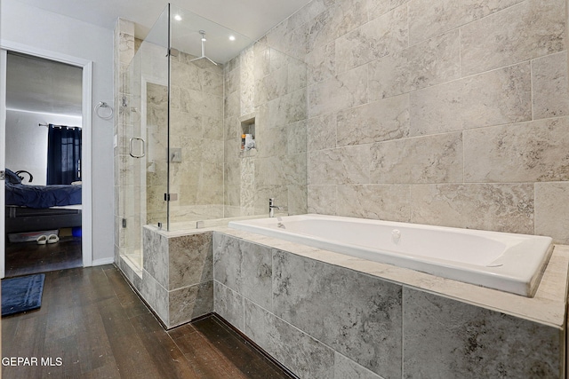 bathroom with independent shower and bath and wood-type flooring