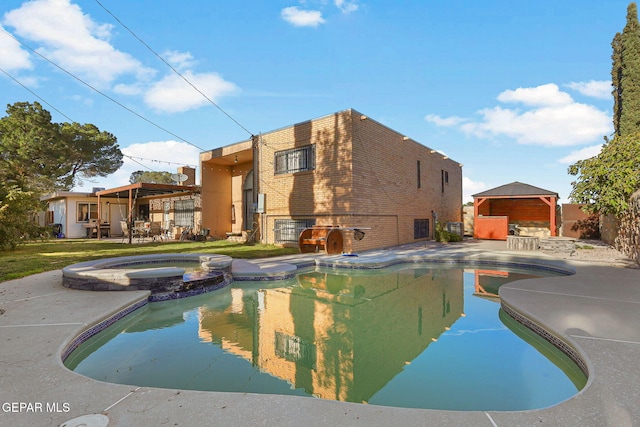 view of swimming pool with a patio and an in ground hot tub