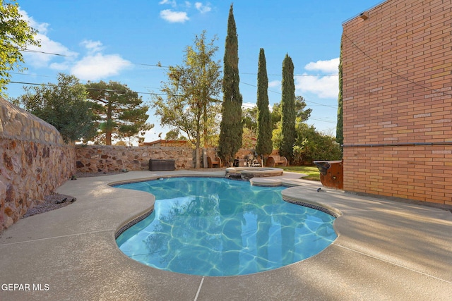 view of pool featuring a patio and an in ground hot tub