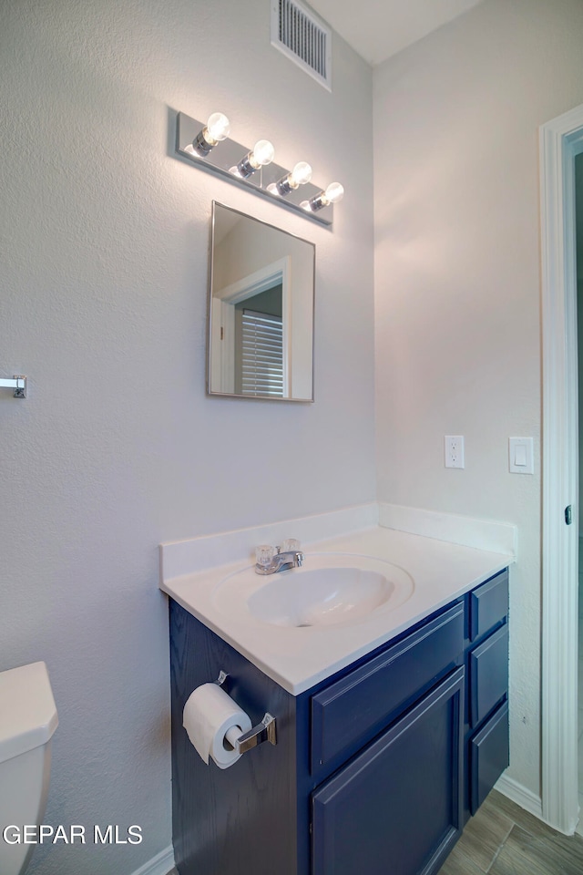 bathroom with vanity and toilet