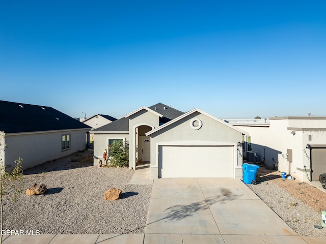 view of front of property with cooling unit and a garage