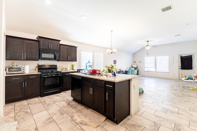 kitchen with an island with sink, black appliances, vaulted ceiling, and a healthy amount of sunlight