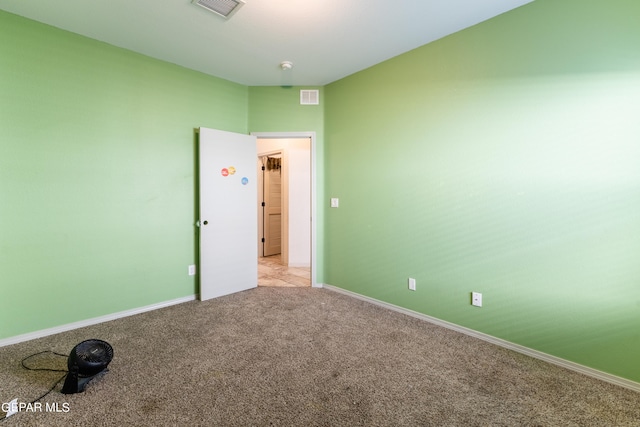 spare room featuring light colored carpet