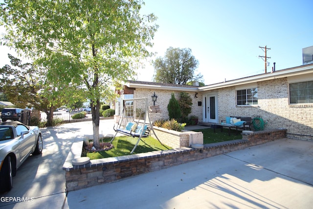 ranch-style house with french doors and a patio area