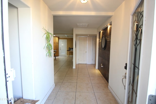 hall with light tile patterned floors