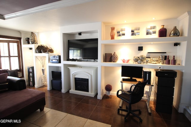 living room featuring built in shelves and dark tile patterned floors