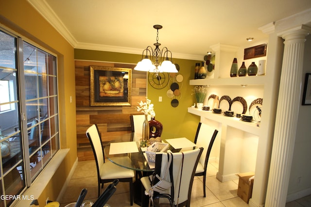 dining room featuring a chandelier, decorative columns, light tile patterned floors, and crown molding