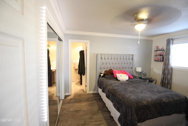 bedroom featuring connected bathroom, ornamental molding, ceiling fan, and dark wood-type flooring