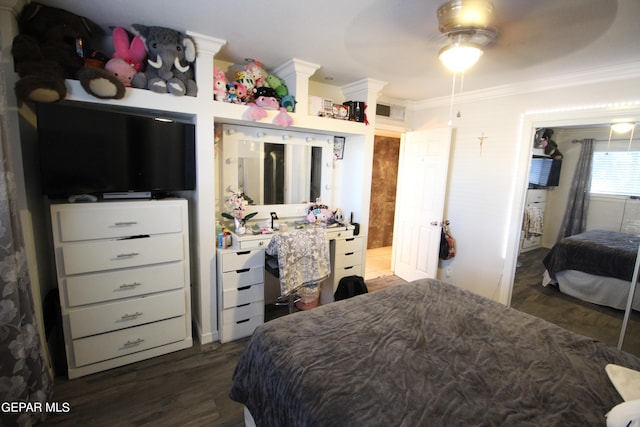 bedroom with ceiling fan, dark hardwood / wood-style floors, and crown molding