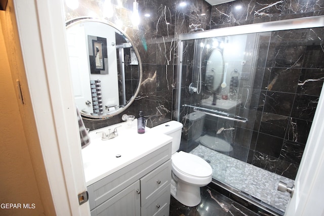 bathroom with vanity, a shower with shower door, and toilet