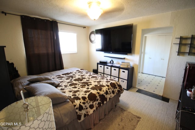 bedroom featuring a textured ceiling and a closet