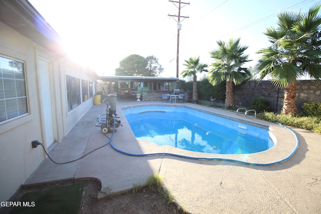 view of swimming pool with a patio