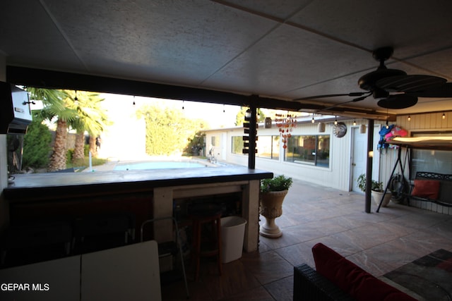 view of patio / terrace with ceiling fan and a jacuzzi