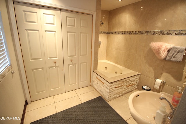 bathroom featuring tile walls, tile patterned flooring, sink, and tiled shower / bath