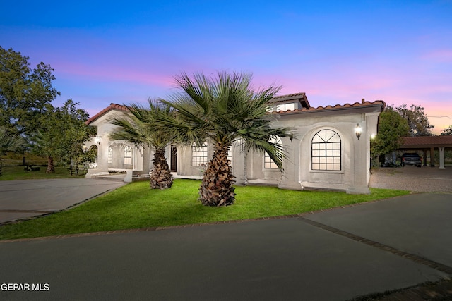 mediterranean / spanish house with a lawn