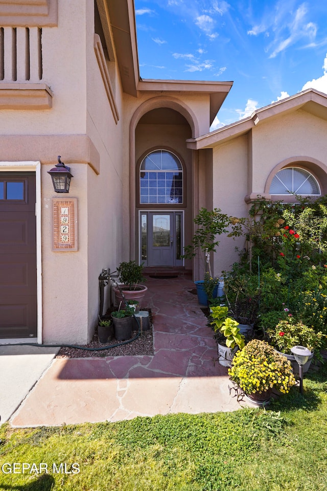 doorway to property with a garage