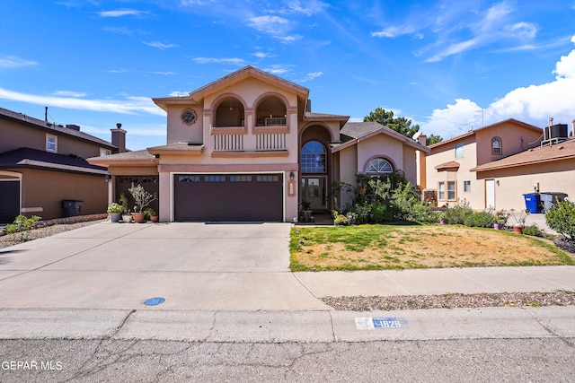 mediterranean / spanish-style home featuring a balcony and a garage